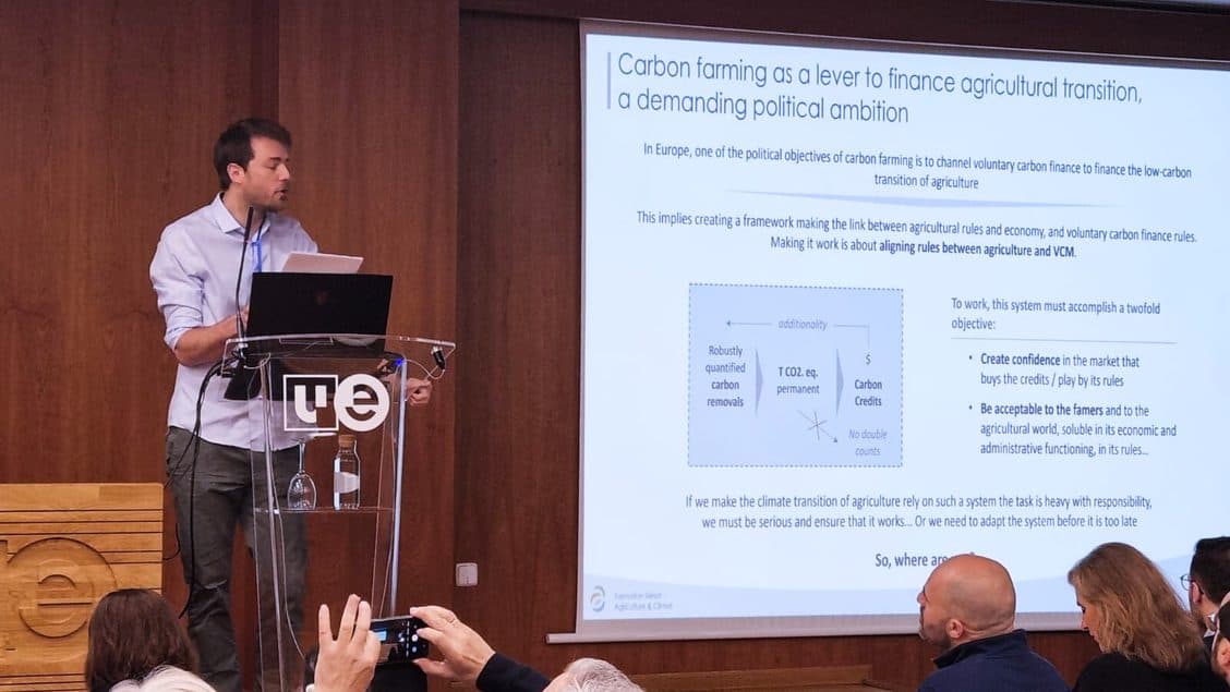 Edouard Lanckriet standing at a podium giving his presentation